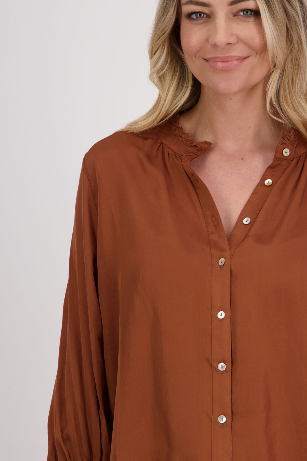 Tan Viscose long sleeve shirt with ruffle collar and shirred sleeves with ruffle. Audrey