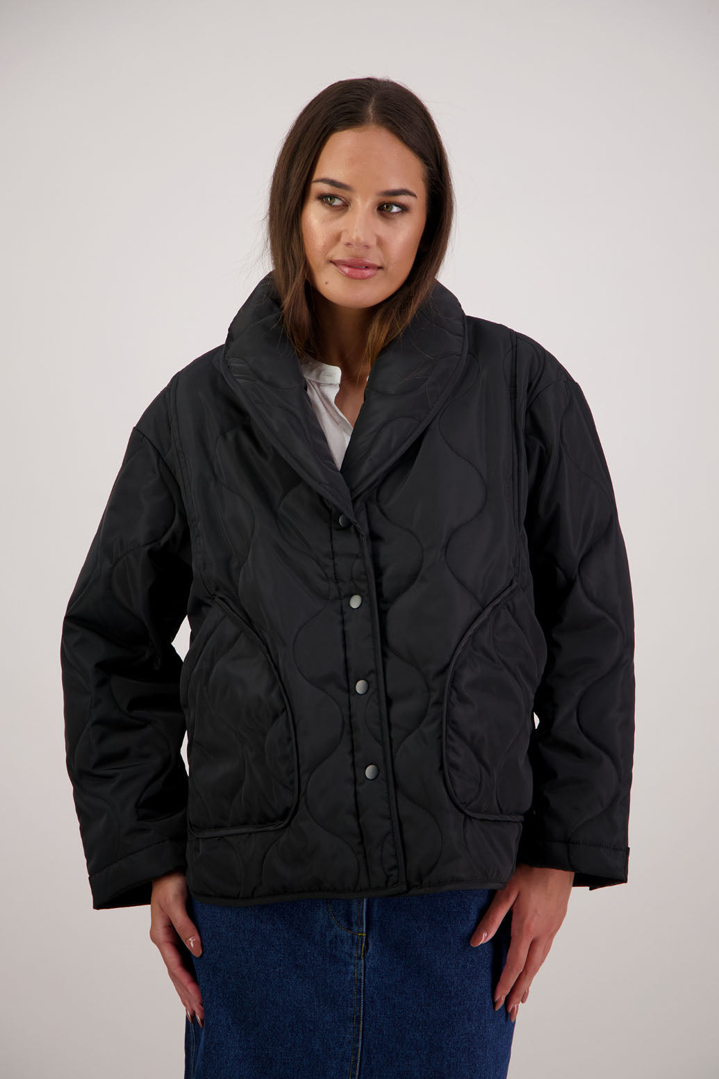 BESTSELLER. Chapman Quilted Jacket in Black by Briarwood NZ. High collar, side split detail, buttons front, stitched on pockets, slightly longer in the back, box fit, lined