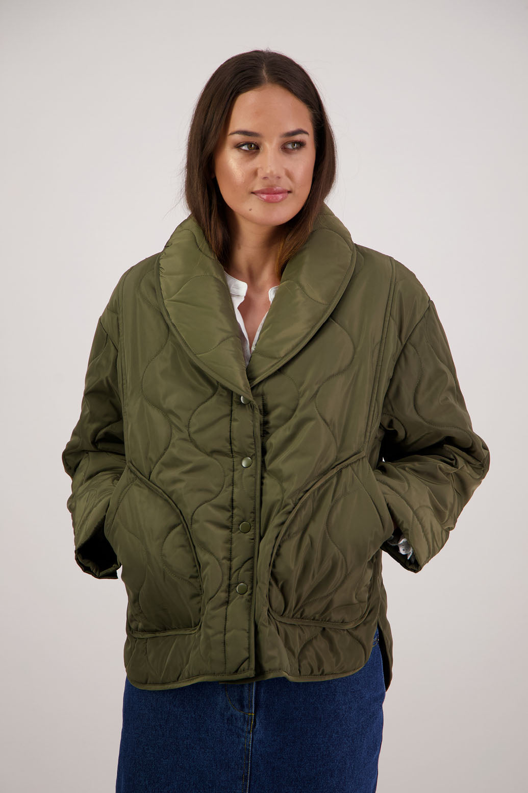 BESTSELLER. Chapman Quilted Jacket in Khaki by Briarwood NZ. Quilted swirl design, high collar, side split detail, buttons front, stitched on pockets, slightly longer in the back, box fit, lined