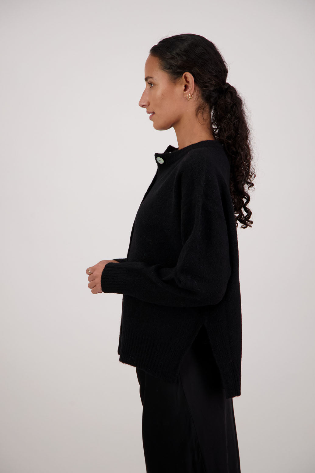 Fable Cardigan in Black by Briarwood NZ. Alpaca/Wool blend long sleeve cardigan with side splits and longer at the back