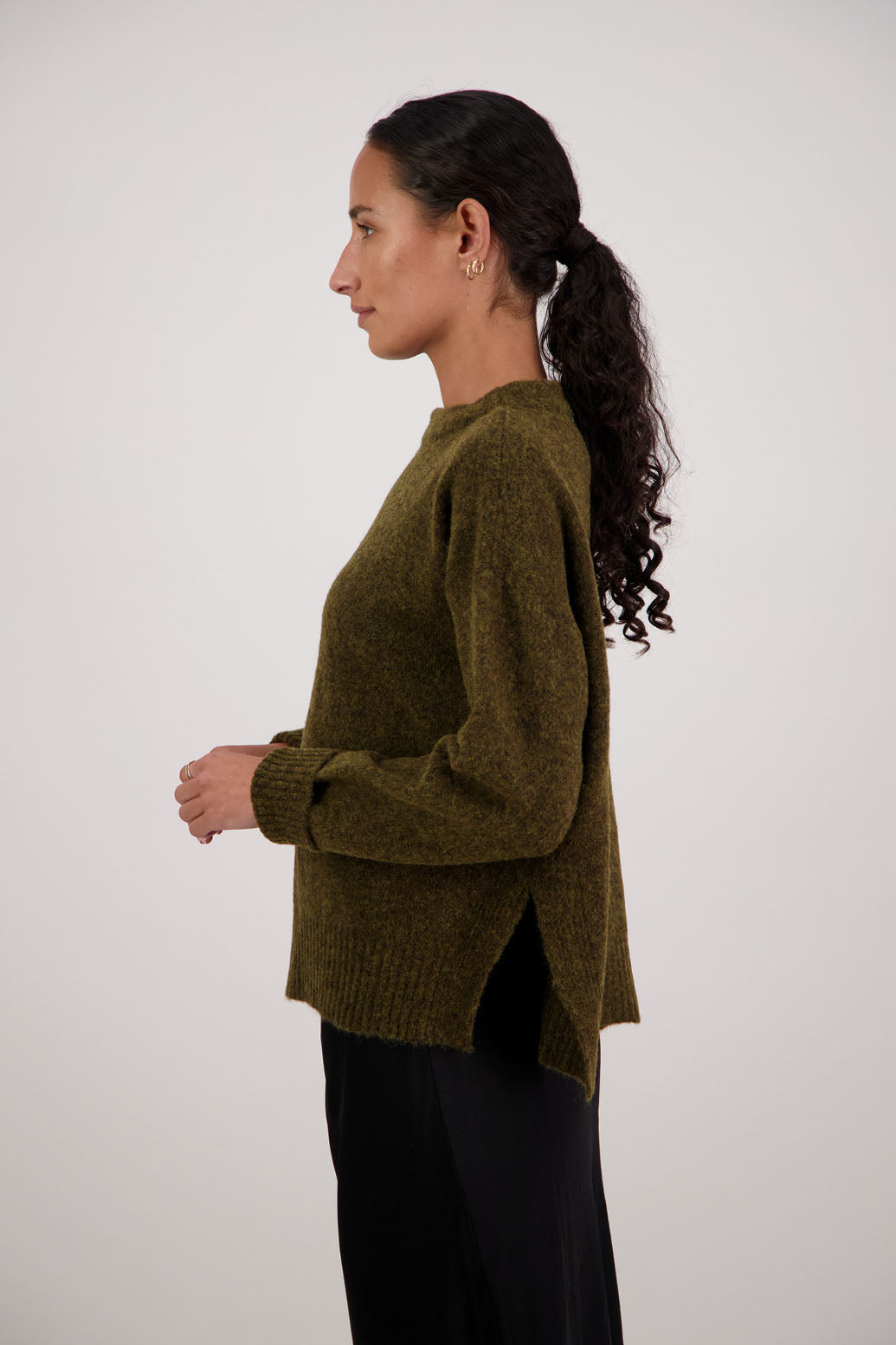 Feather Jumper in Olive by Briarwood NZ. Alpaca/Wool blend long sleeve, funnel neck jumper with side splits and longer at the back