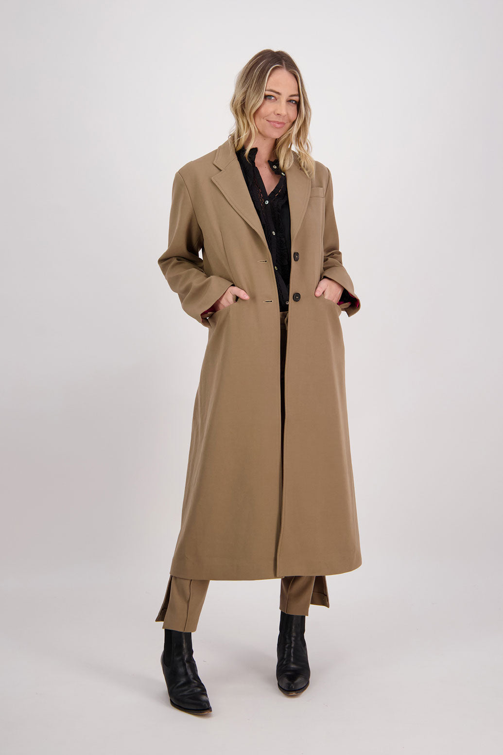 Camel tailored long coat with fuchsia lining. Lapel pockets and high back split. Hannah