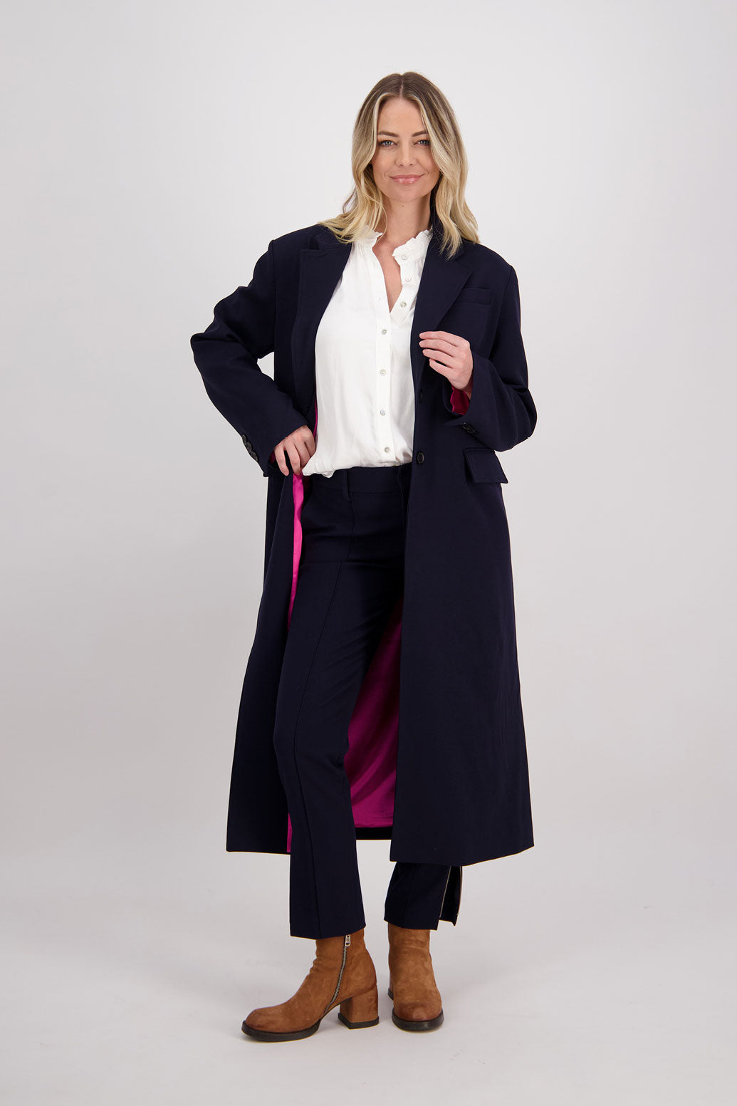 Ink/Dark Blue tailored long coat with fuchsia lining. Lapel pockets and high back split. Hannah