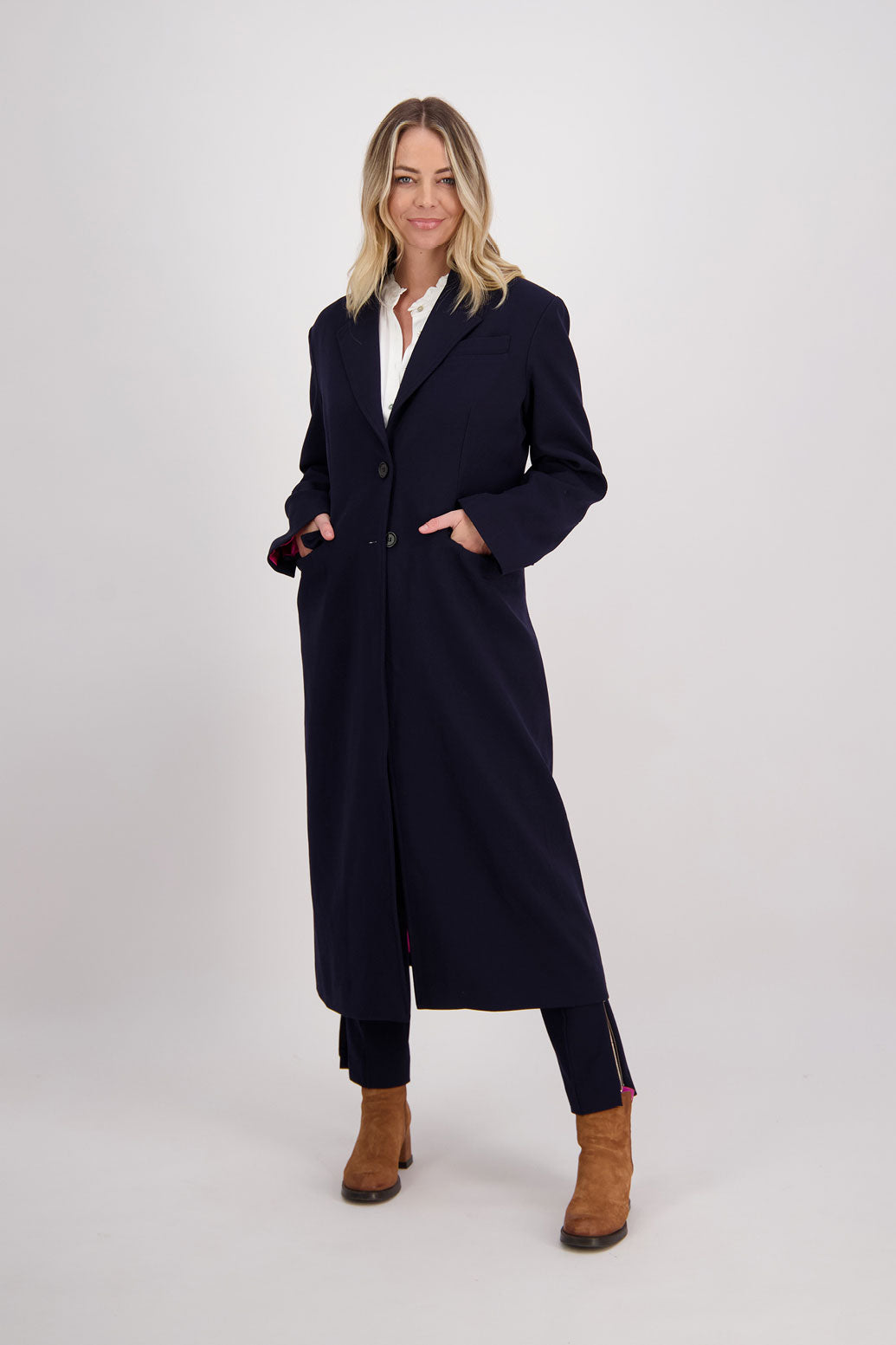 Ink/Dark Blue tailored long coat with fuchsia lining. Lapel pockets and high back split. Hannah