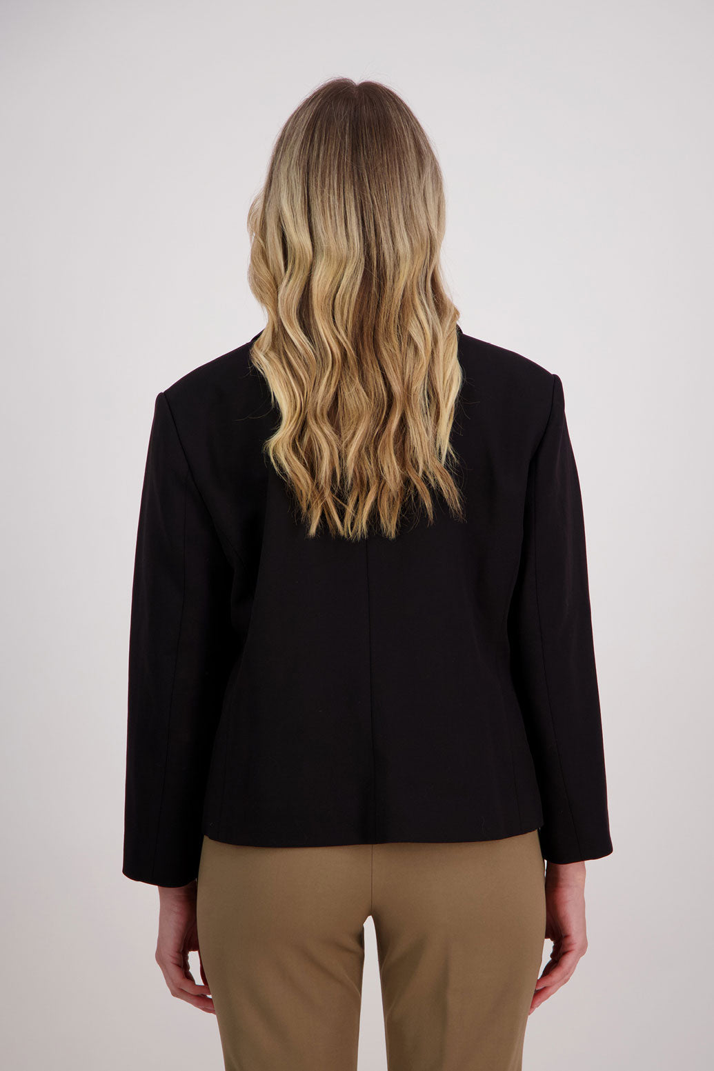 Black blazer with subtle shaping and fuchsia/pink lining. Harris