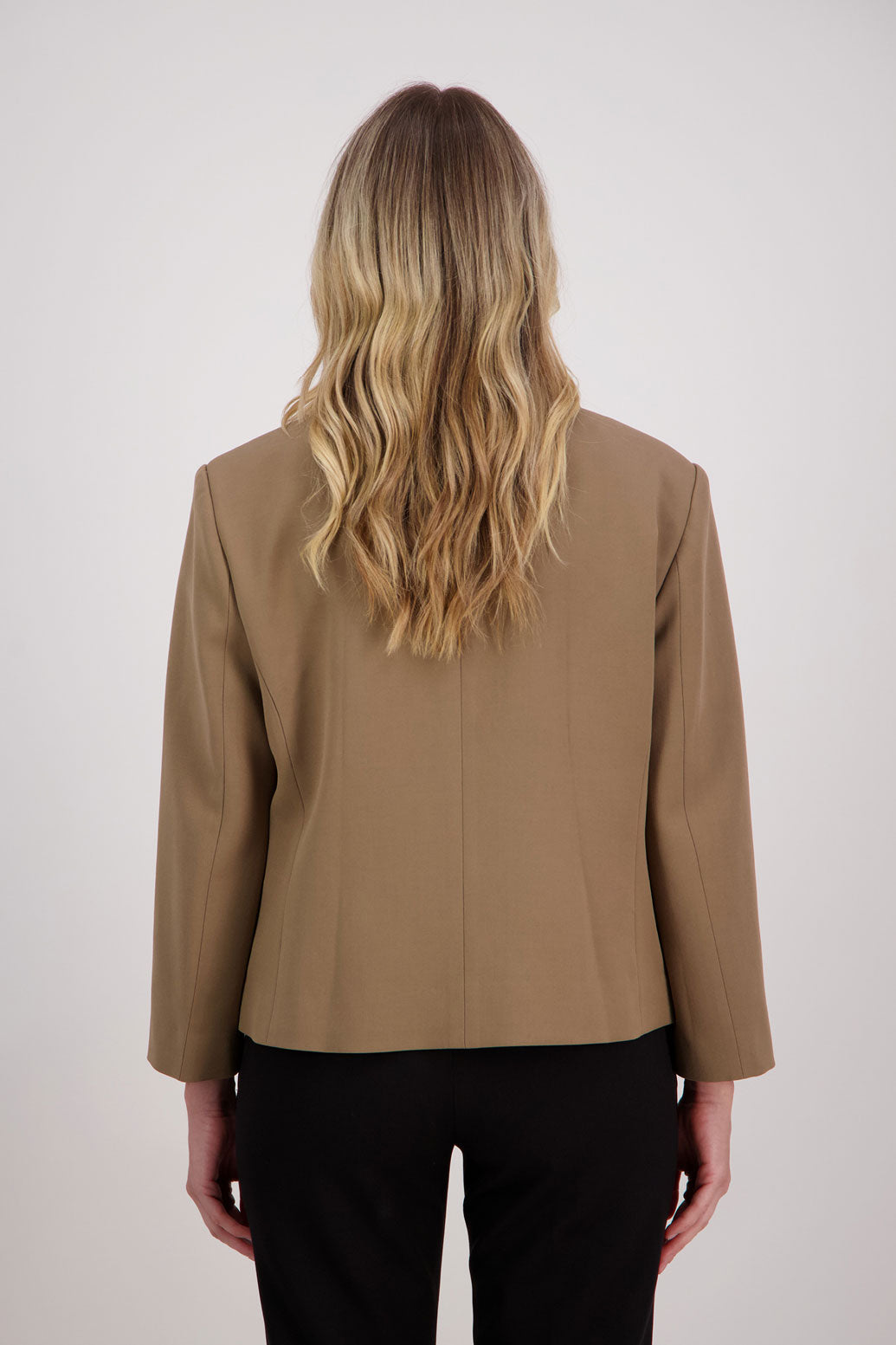 Camel blazer with subtle shaping and fuchsia/pink lining. Harris