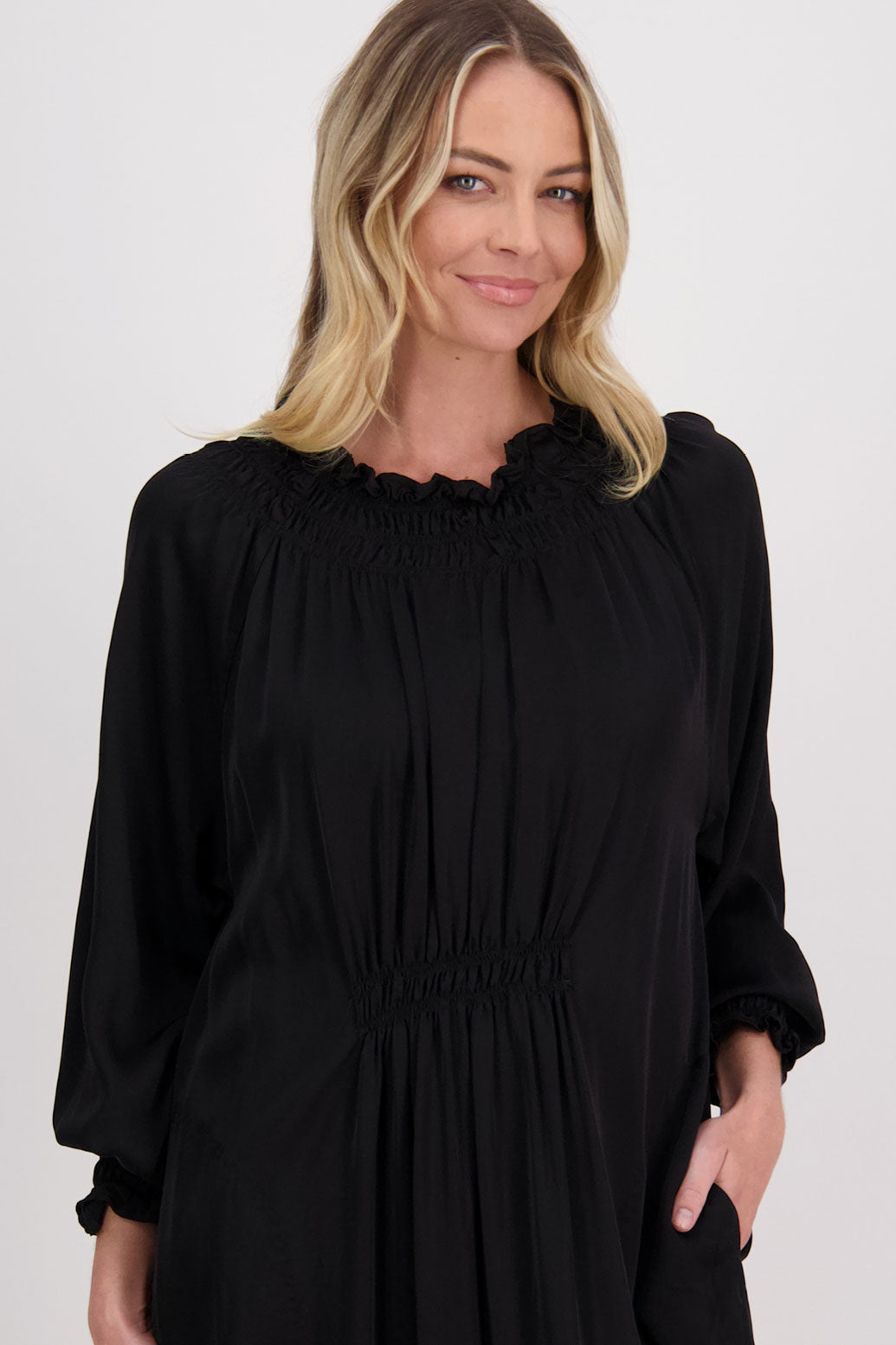 Black Briarwood viscose full length dress with shirt hem detail. Shirred detail around the neck, waist and sleeves. Shirred waistline detail at front and back gives gentle shape. Henna