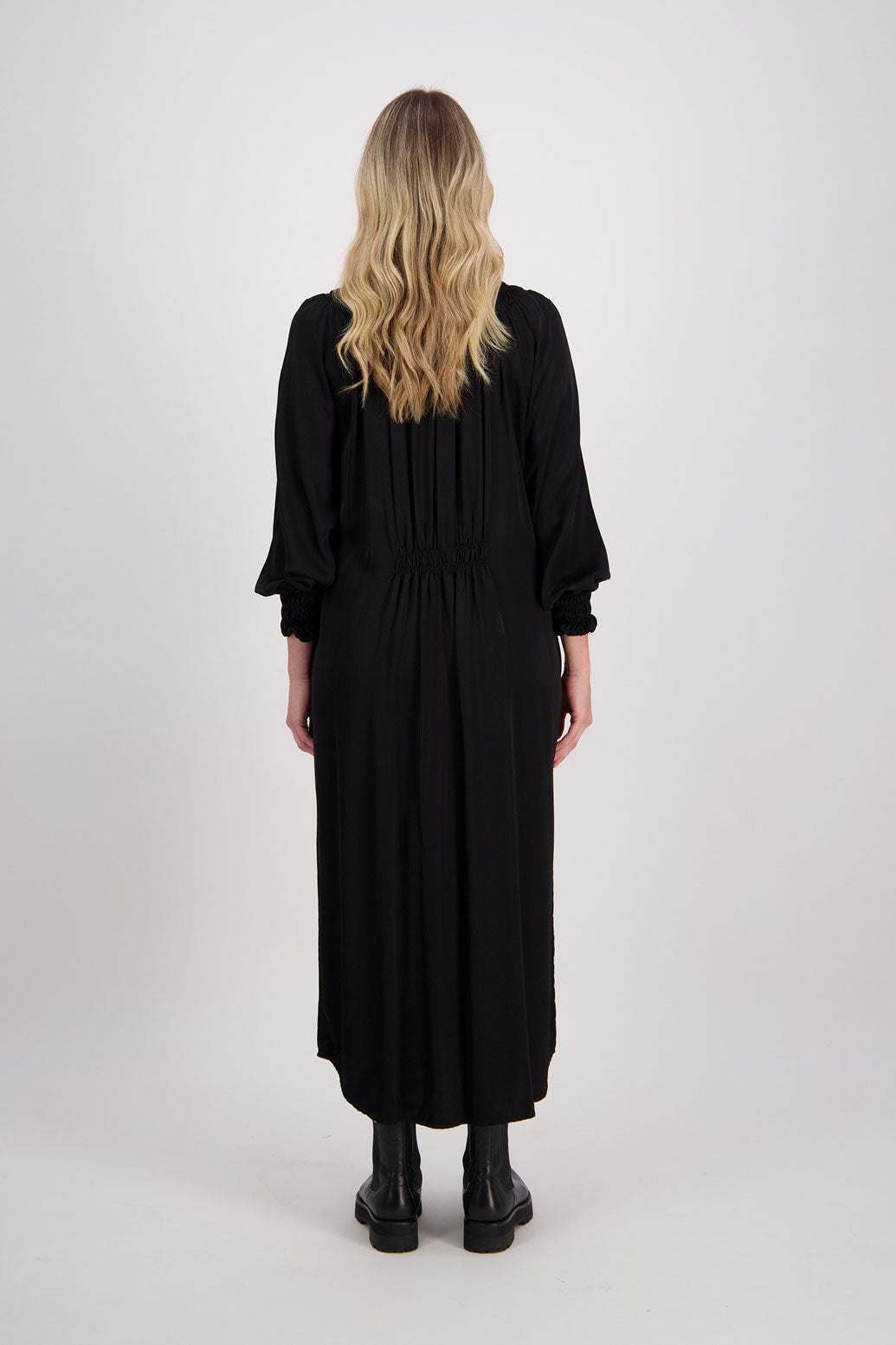 Black Briarwood viscose full length dress with shirt hem detail. Shirred detail around the neck, waist and sleeves. Shirred waistline detail at front and back gives gentle shape. Henna