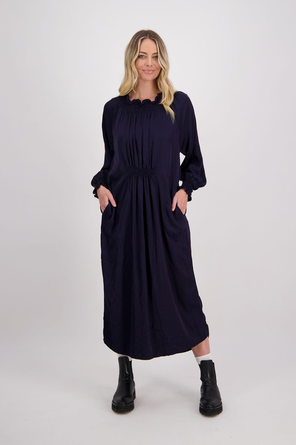 Ink/Navy Blue Briarwood viscose full length dress with shirt hem detail. Shirred detail around the neck, waist and sleeves. Shirred waistline detail at front and back gives gentle shape. Henna