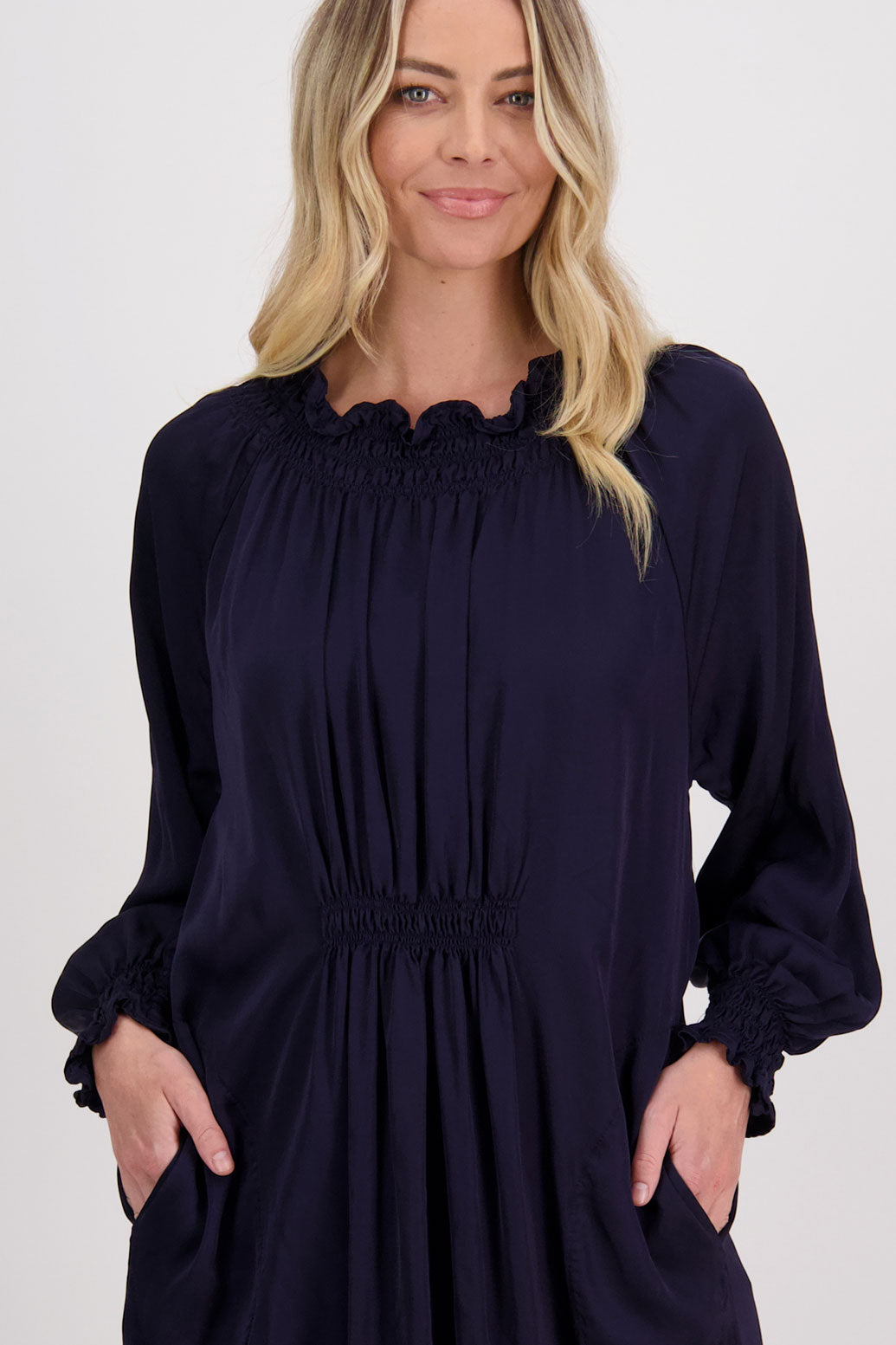 Ink/Navy Blue Briarwood viscose full length dress with shirt hem detail. Shirred detail around the neck, waist and sleeves. Shirred waistline detail at front and back gives gentle shape. Henna