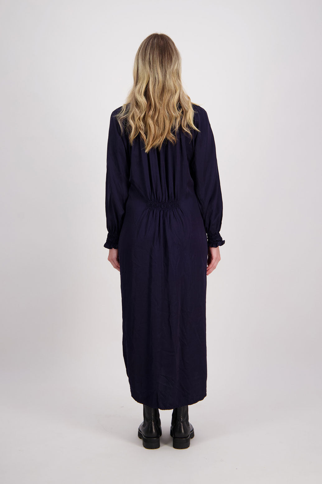 Ink/Navy Blue Briarwood viscose full length dress with shirt hem detail. Shirred detail around the neck, waist and sleeves. Shirred waistline detail at front and back gives gentle shape. Henna