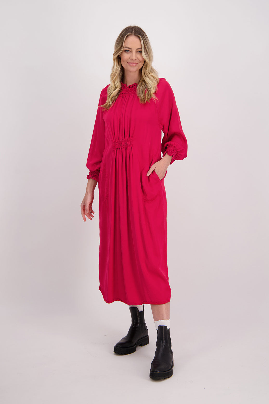 Red Briarwood viscose full length dress with shirt hem detail. Shirred detail around the neck, waist and sleeves. Shirred waistline detail at front and back gives gentle shape. Henna