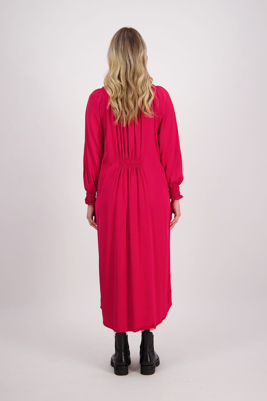 Red Briarwood viscose full length dress with shirt hem detail. Shirred detail around the neck, waist and sleeves. Shirred waistline detail at front and back gives gentle shape. Henna