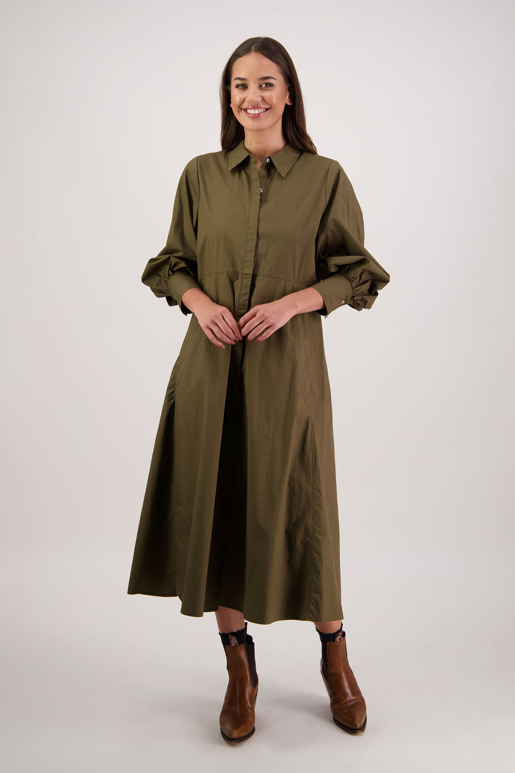 Henrietta Shirt Dress in Khaki by Briarwood NZ. Made from Cotton Poplin with long full length sleeves, fitted through the body, fitted through the maxi with maxi a-line skirt, hidden button front and extended cuff with 2 buttons
