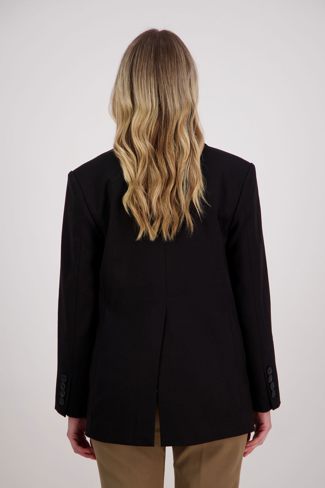 Black longline blazer with fucshia lining. Hilary