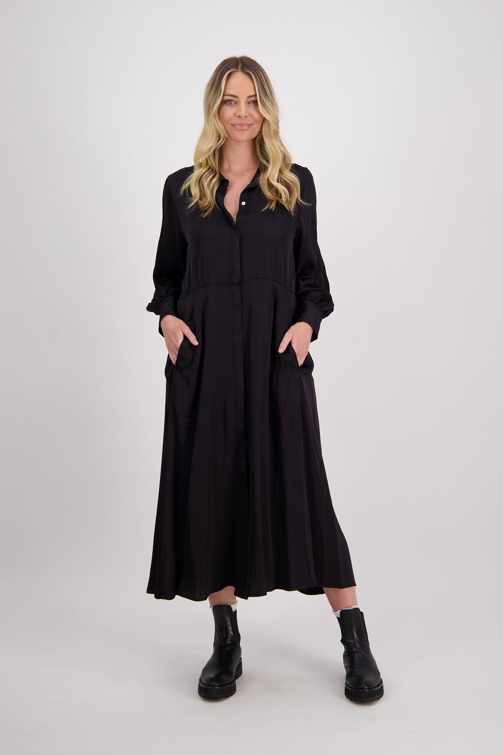 Black Shirt Dress, maxi length, long sleeves. Fitted through the body draping to A Line skirt. Hidden button front with extended cuffs. Hollie