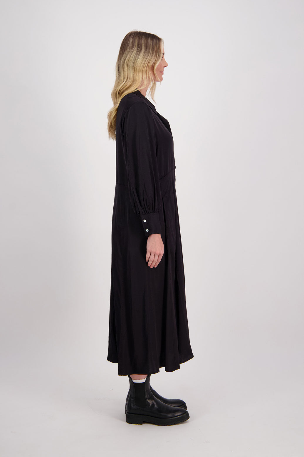 Black Shirt Dress, maxi length, long sleeves. Fitted through the body draping to A Line skirt. Hidden button front with extended cuffs. Hollie