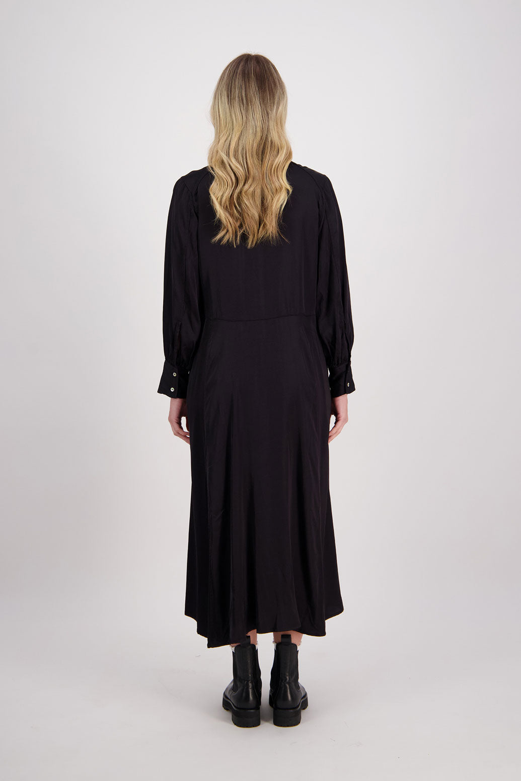 Black Shirt Dress, maxi length, long sleeves. Fitted through the body draping to A Line skirt. Hidden button front with extended cuffs. Hollie