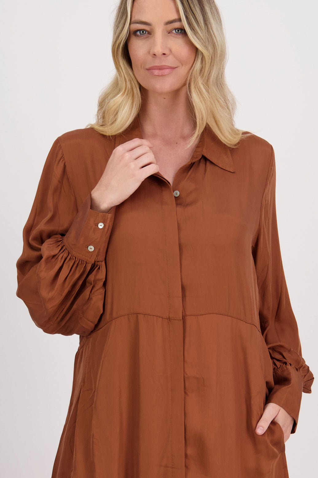 Tan Shirt Dress, maxi length, long sleeves. Fitted through the body draping to A Line skirt. Hidden button front with extended cuffs. Hollie