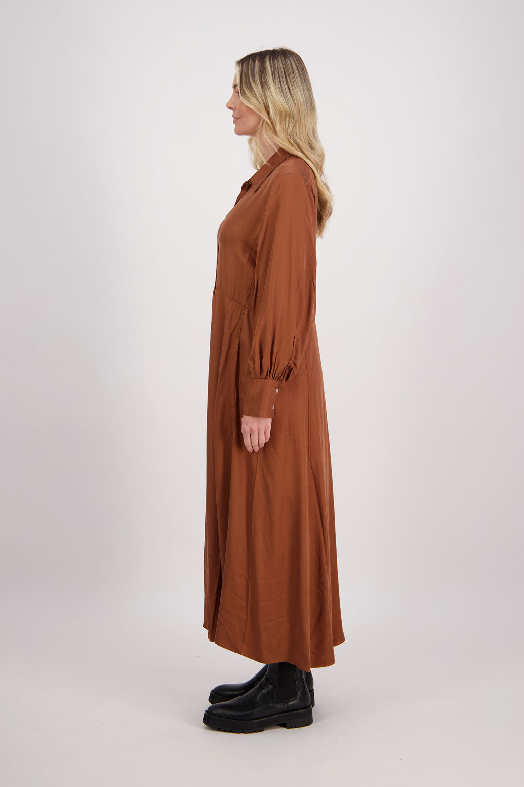 Tan Shirt Dress, maxi length, long sleeves. Fitted through the body draping to A Line skirt. Hidden button front with extended cuffs. Hollie