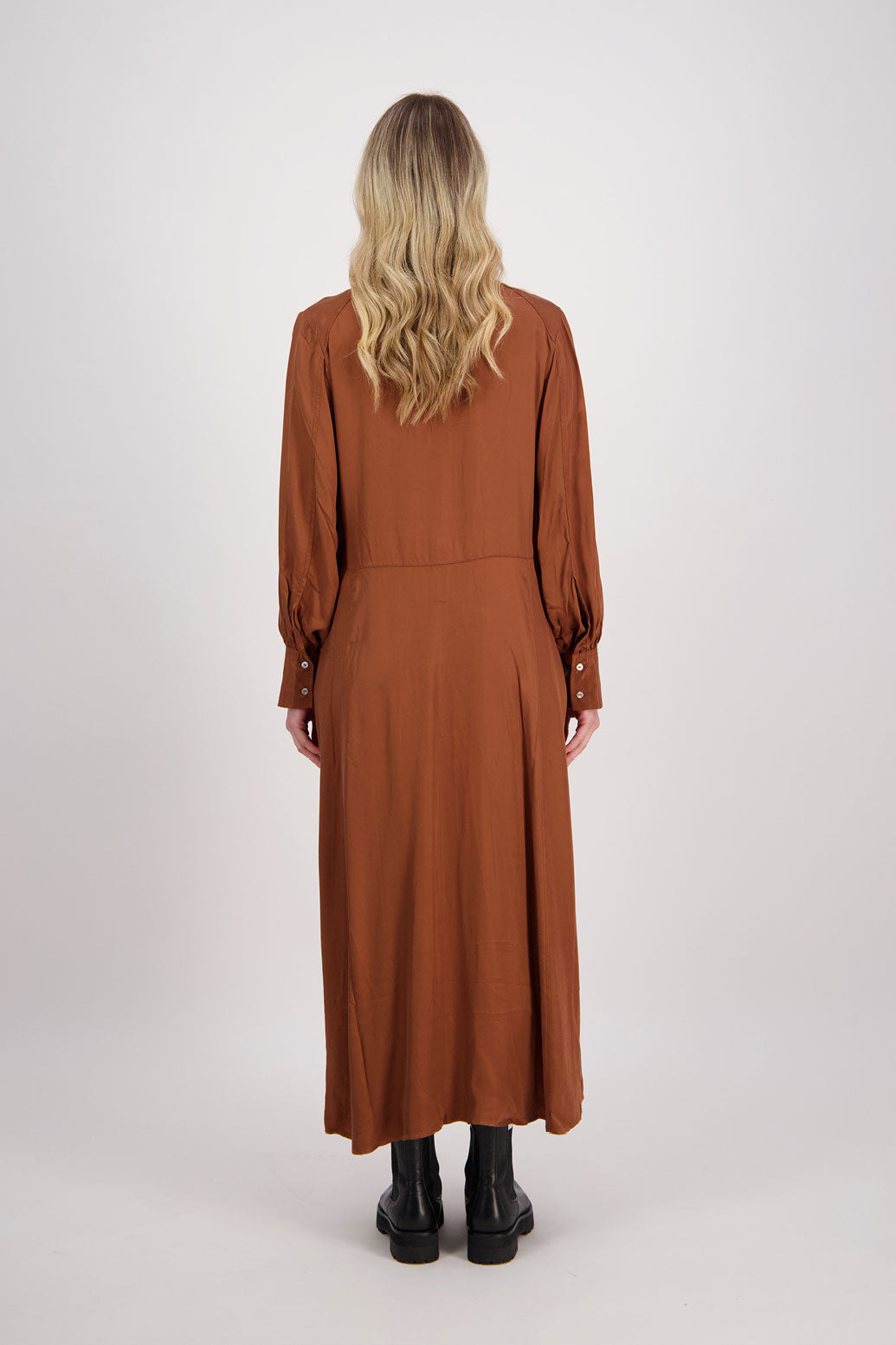 Tan Shirt Dress, maxi length, long sleeves. Fitted through the body draping to A Line skirt. Hidden button front with extended cuffs. Hollie