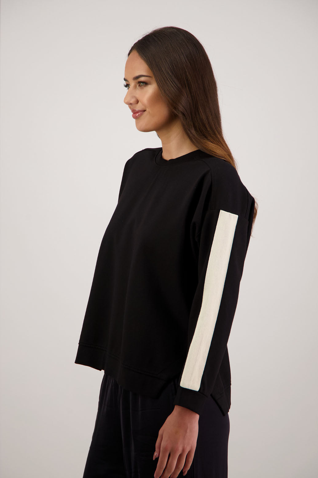 BESTSELLER. Holmes Sweatshirt in Black by Briarwood NZ. Ponte sweatshirt with full length sleeves, side split hem and contrast side stripe