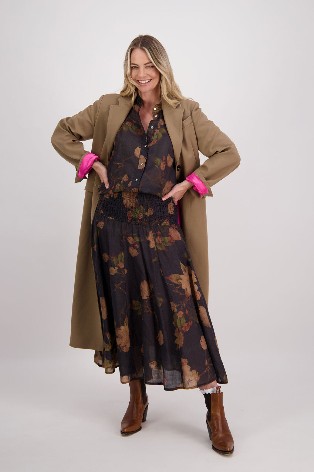 Camel tailored long coat with fuchsia lining. Lapel pockets and high back split. Hannah