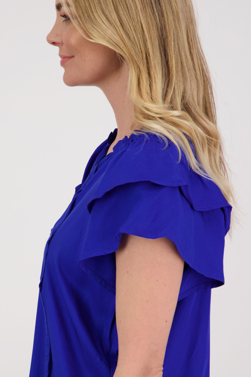 Pansy Womens Short Sleeve top with V Neck and Tie. Double ruffle over the shoulder and shaped hem. Bright Blue