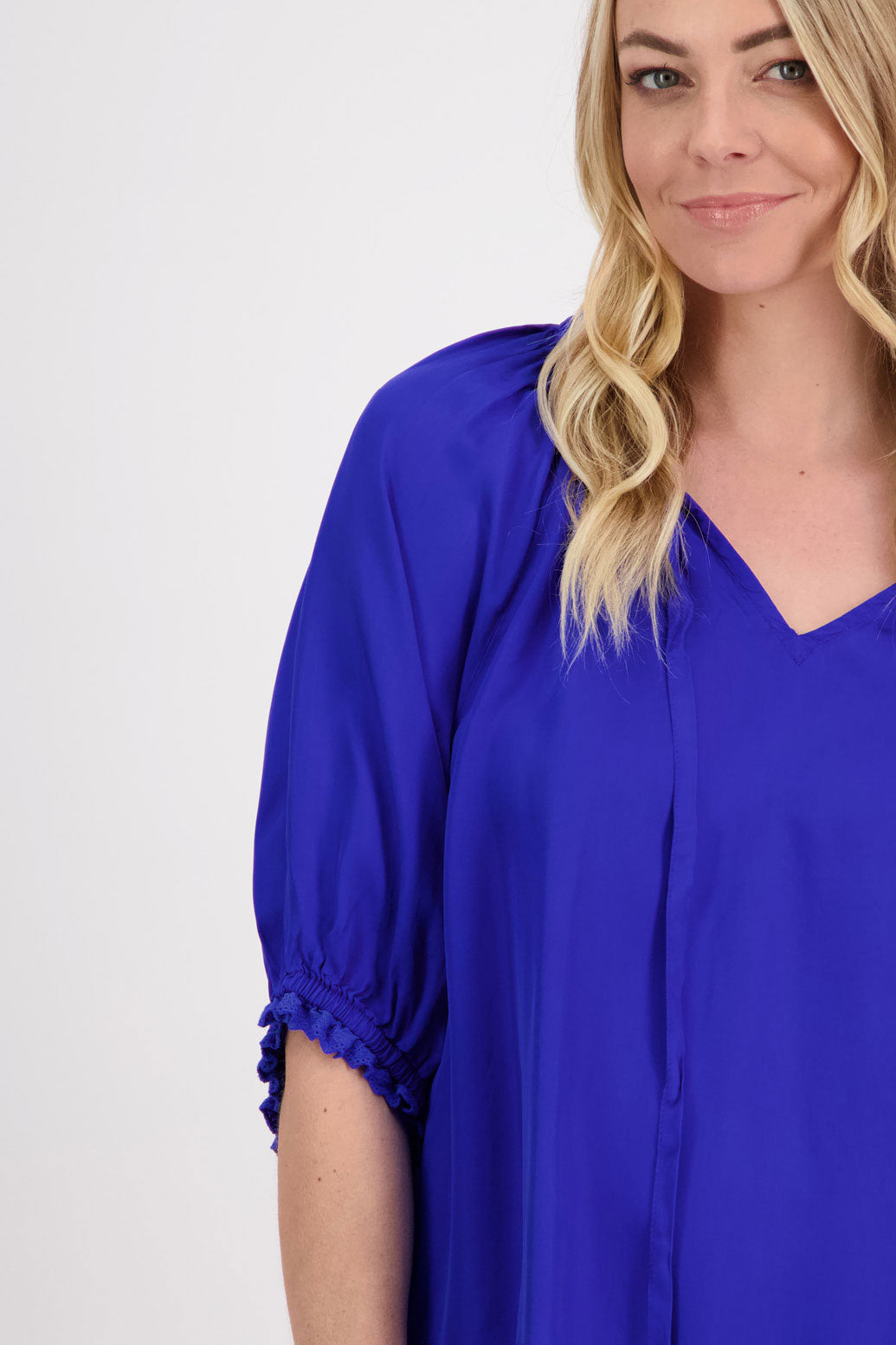 Pebbles Womens Bright Blue Viscose Top with longer short sleeves and V neck with tie. Ruffle around the neck and sleeves. Slightly longer at the back.