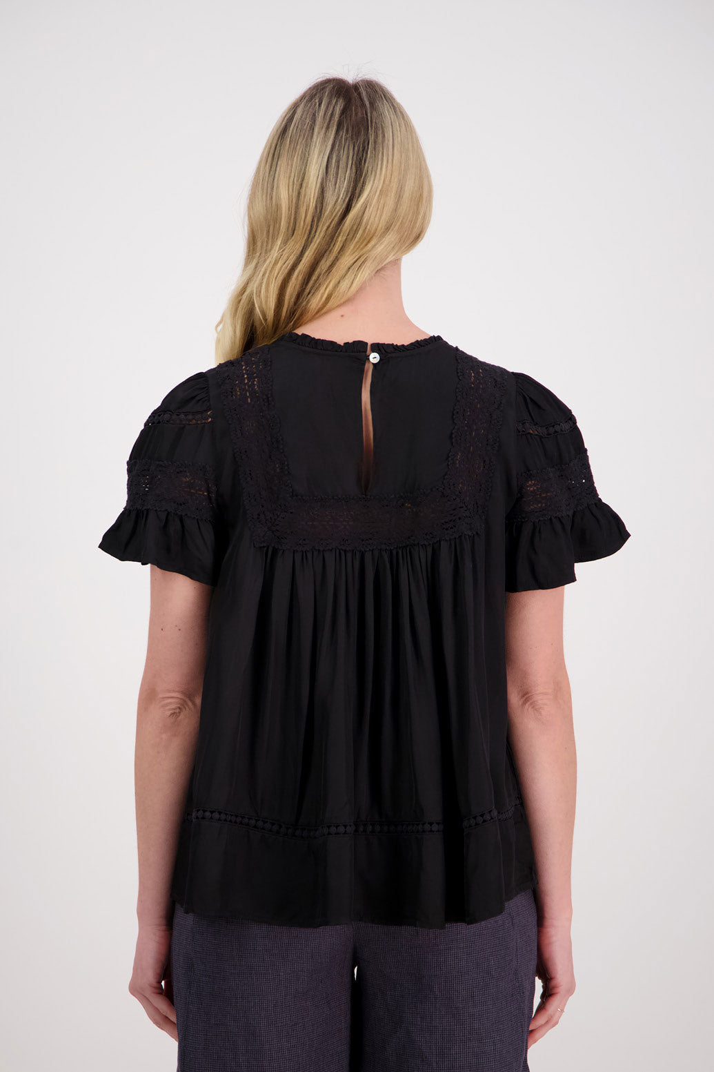 Perkins Womens Reversible Top. Wear as a V neck front or turn it around and close the single button at the back. Black