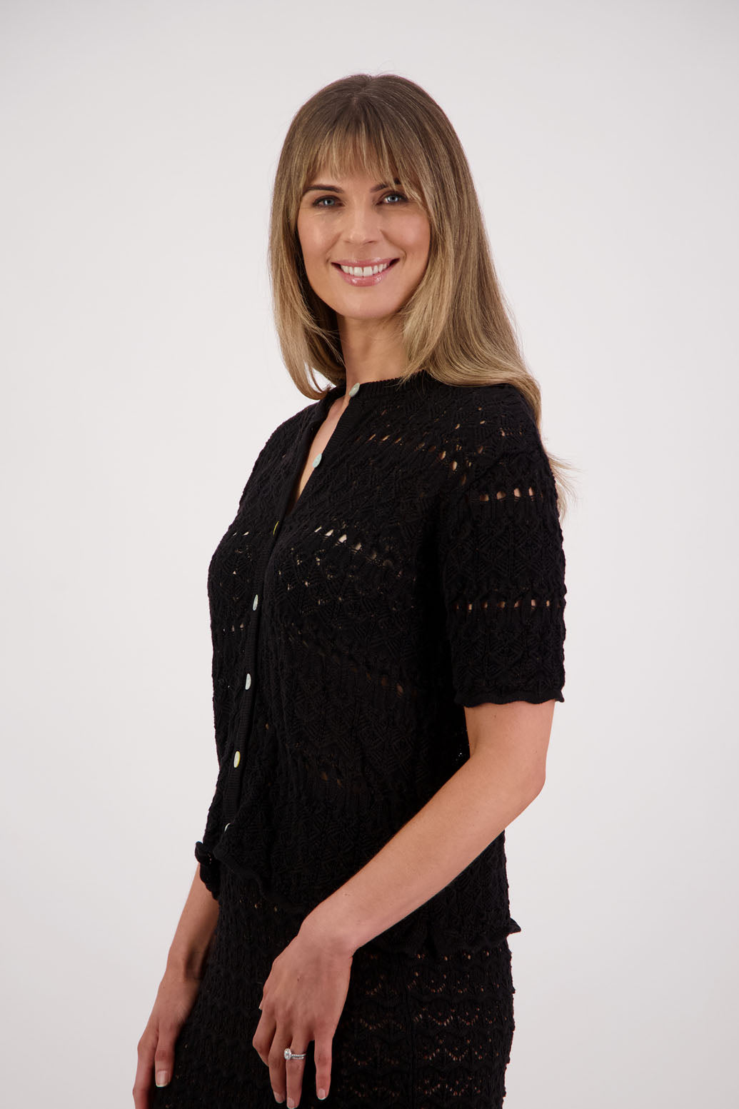 Womens knitted cotton lace short sleeve cardigan with shaped hem and scalloped edging. Briarwood NZ. Posy, Black