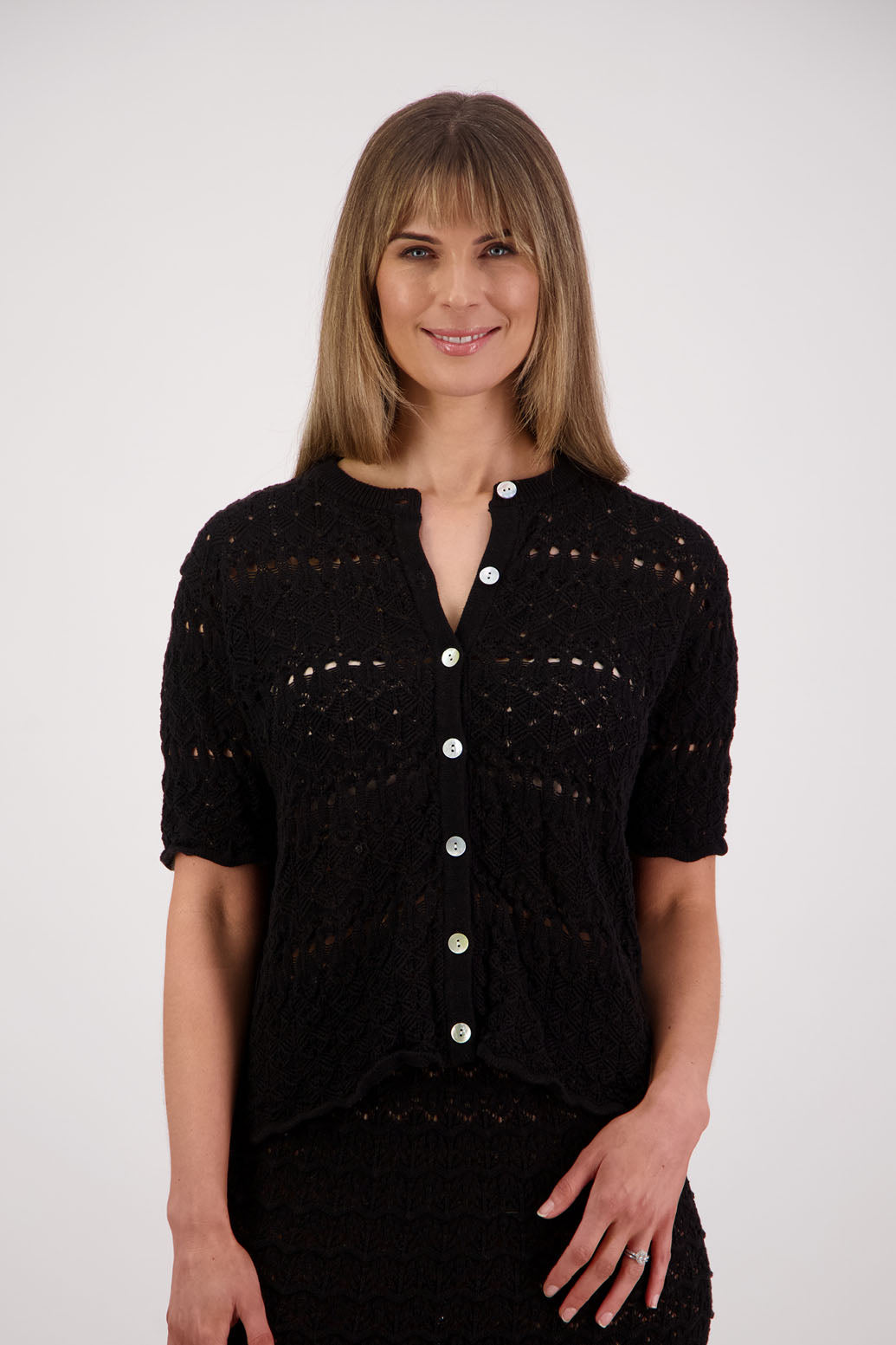 Womens knitted cotton lace short sleeve cardigan with shaped hem and scalloped edging. Briarwood NZ. Posy, Black