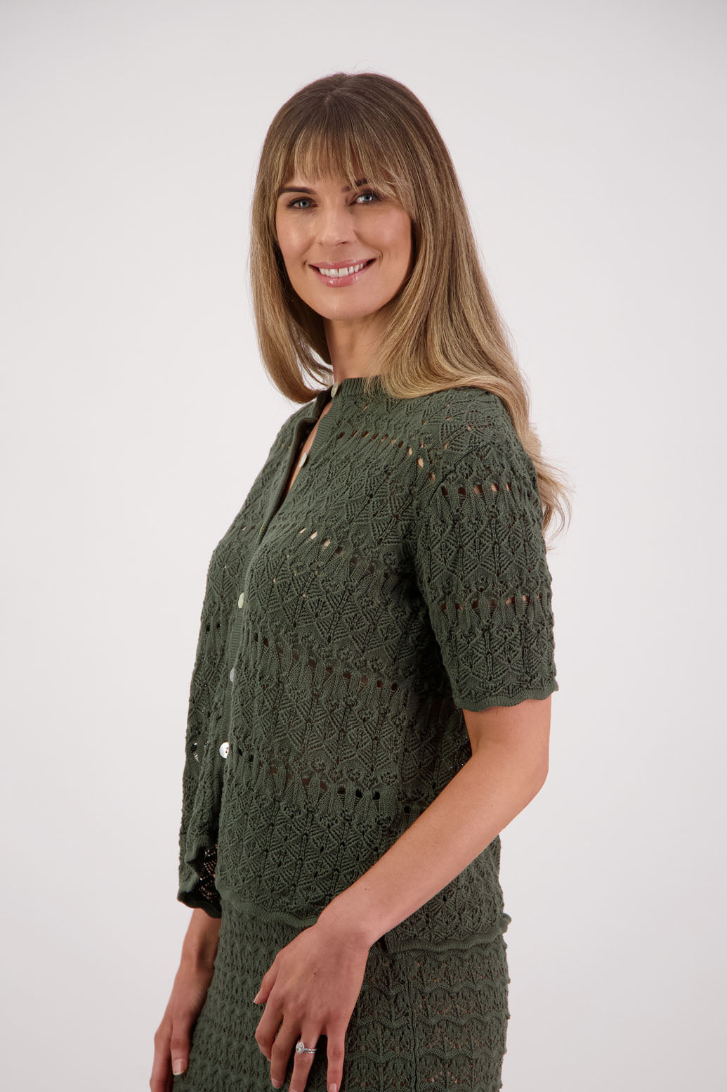 Womens knitted cotton lace short sleeve cardigan with shaped hem and scalloped edging. Briarwood NZ. Posy, Moss Green