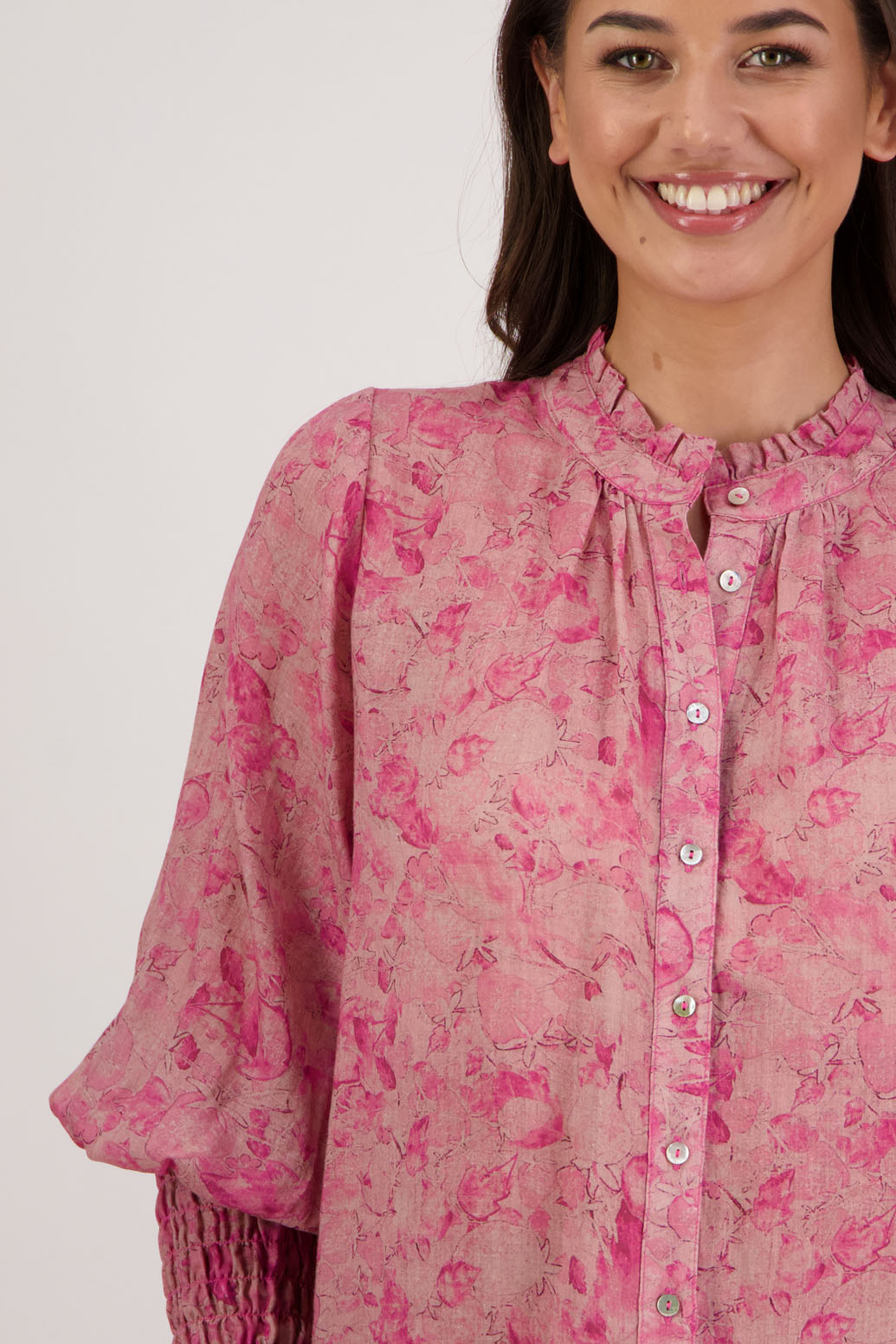 Raewyn Shirt in Pink Floral by Briarwood NZ. 100% Ramie shirt with long sleeves, ruffle neckline, shirred waist and button front.
