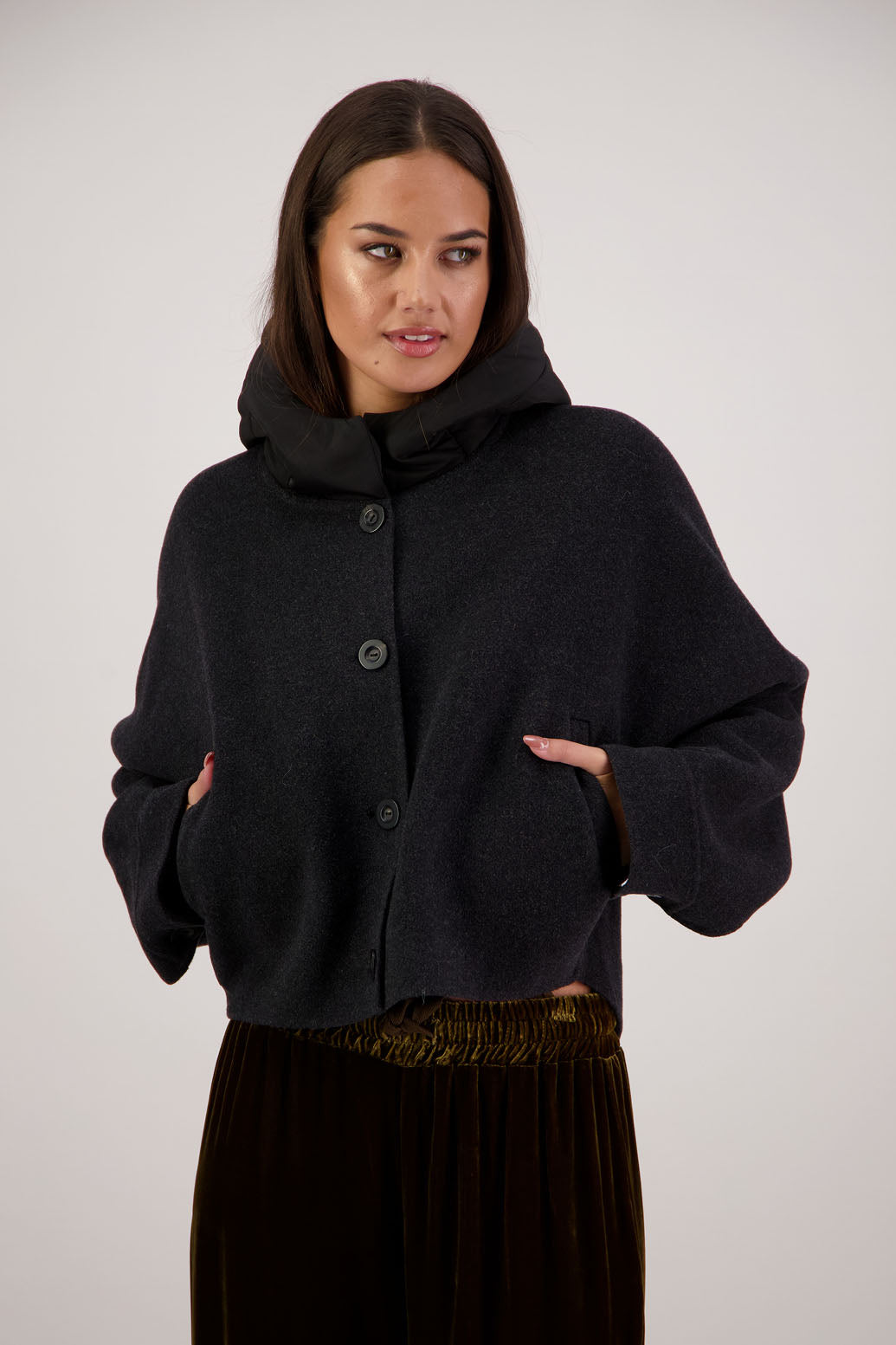 Raine Jacket in Black by Briarwood NZ. Features, wool/cashmere/polyester body, short and wide, bat wing type sleeve, nylon hood with magnetic closure, pockets, buttons down the front