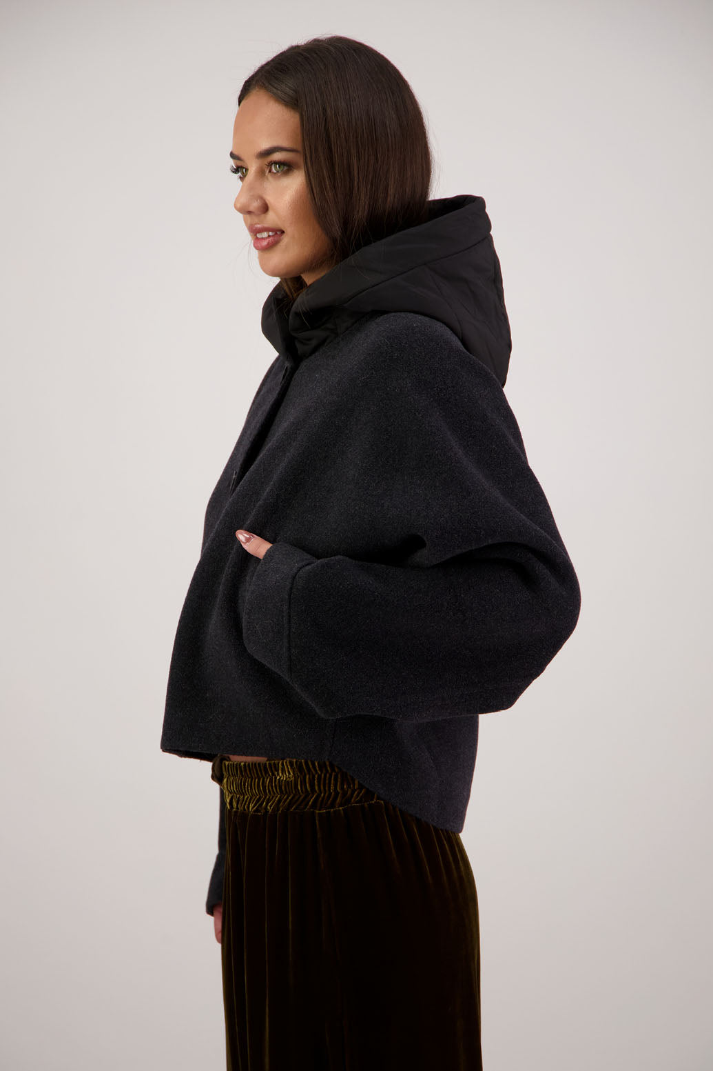 Raine Jacket in Black by Briarwood NZ. Features, wool/cashmere/polyester body, short and wide, bat wing type sleeve, nylon hood with magnetic closure, pockets, buttons down the front