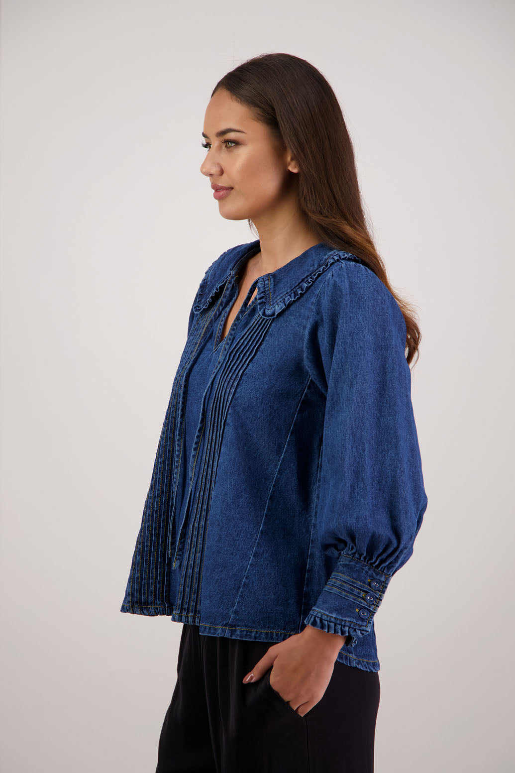 Redmond Denim Top by Briarwood NZ. 100% cotton top with pin tucks, shaped collar with ruffle and tie, full length sleeves with pin tucks on buttoned cuff
