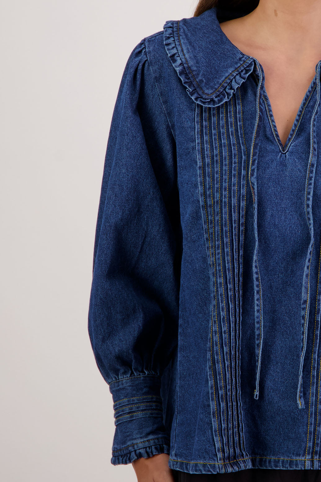 Redmond Denim Top by Briarwood NZ. 100% cotton top with pin tucks, shaped collar with ruffle and tie, full length sleeves with pin tucks on buttoned cuff