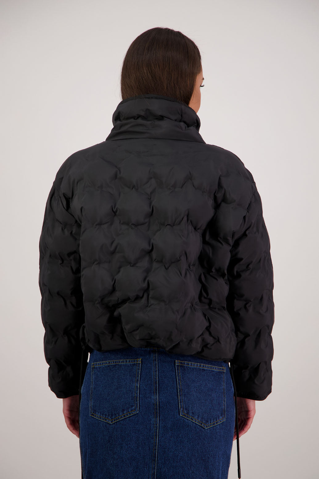 Rhodes Padded Jacket in Black by Briarwood NZ. Features, magnetic dome closures, filled with plush fibres, elastic pull across the back with toggles to hold it in place, high collar with invisible magnetic closure, pockets