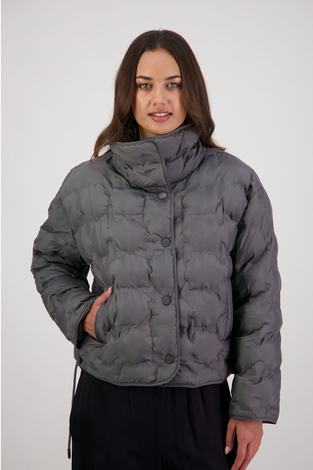 Rhodes Padded Jacket in Charcoal by Briarwood NZ. Features, magnetic dome closures, filled with plush fibres, elastic pull across the back with toggles to hold it in place, high collar with invisible magnetic closure, pockets