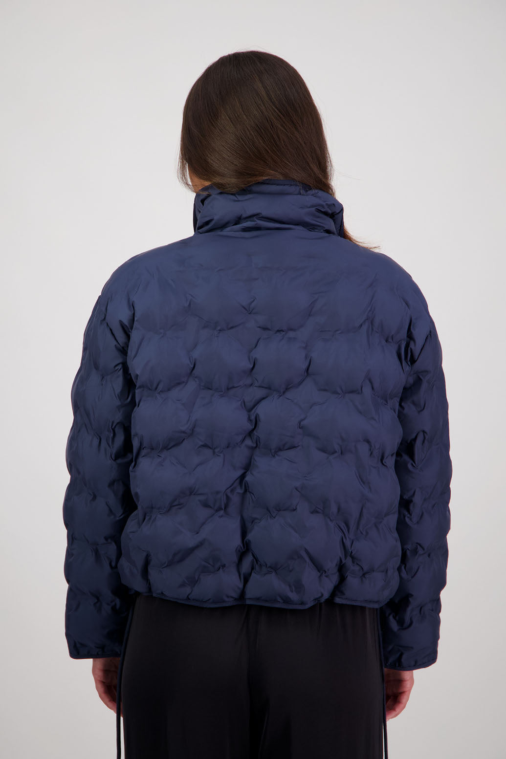 Rhodes Padded Jacket in Ink by Briarwood NZ. Features, magnetic dome closures, filled with plush fibres, elastic pull across the back with toggles to hold it in place, high collar with invisible magnetic closure, pockets