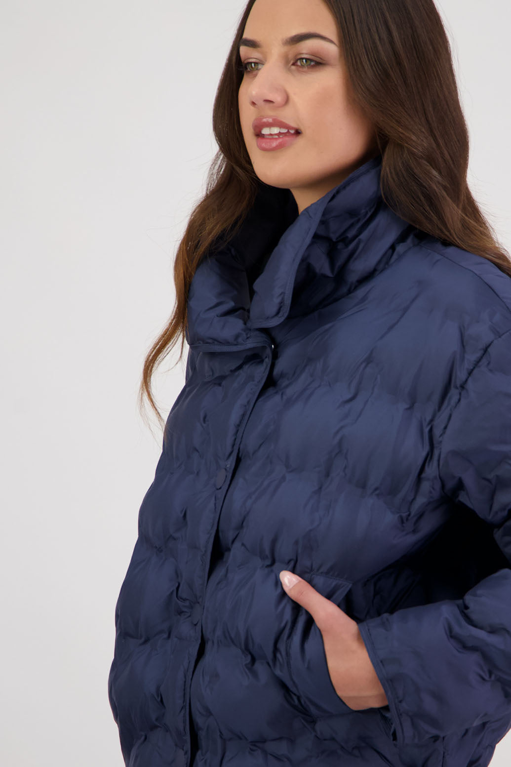 Rhodes Padded Jacket in Ink by Briarwood NZ. Features, magnetic dome closures, filled with plush fibres, elastic pull across the back with toggles to hold it in place, high collar with invisible magnetic closure, pockets