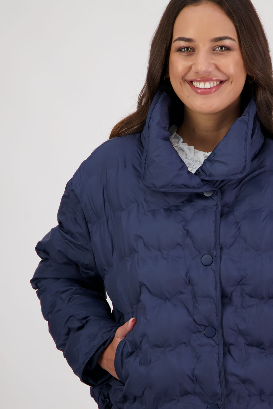 Rhodes Padded Jacket in Ink by Briarwood NZ. Features, magnetic dome closures, filled with plush fibres, elastic pull across the back with toggles to hold it in place, high collar with invisible magnetic closure, pockets