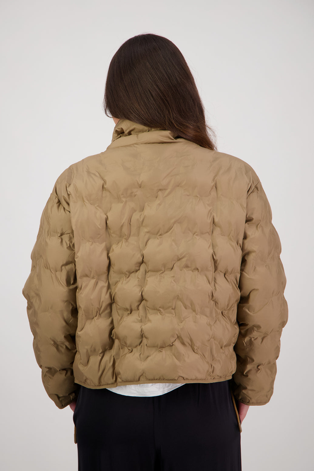 Rhodes Padded Jacket in Tan by Briarwood NZ. Features, magnetic dome closures, filled with plush fibres, elastic pull across the back with toggles to hold it in place, high collar with invisible magnetic closure, pockets