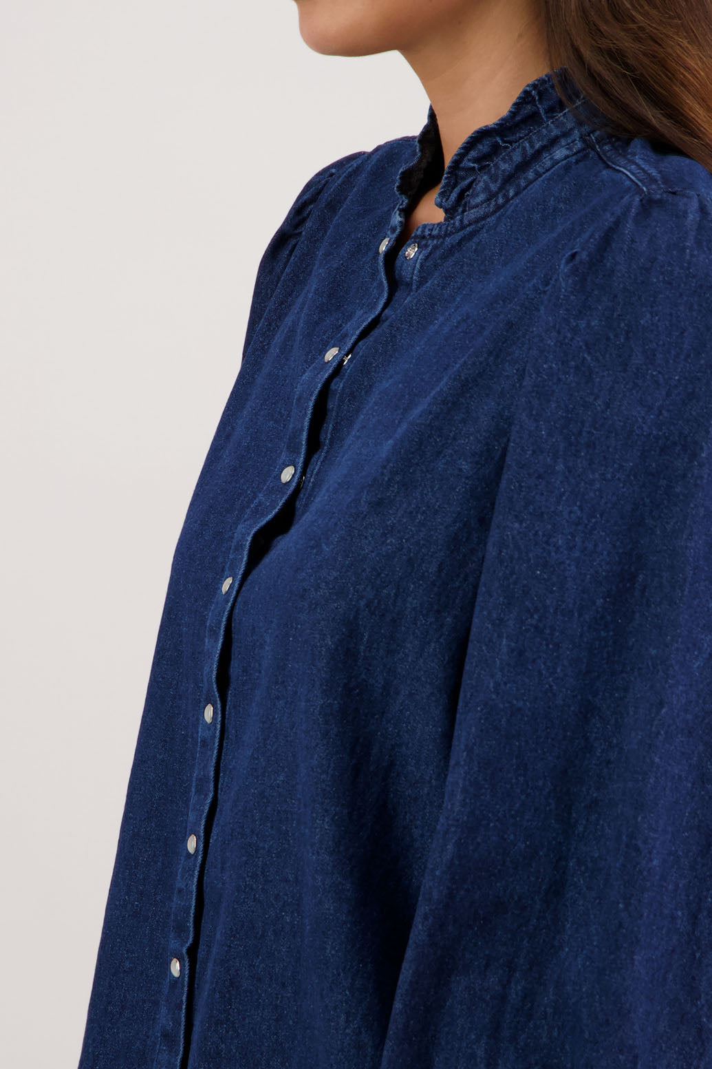 Ricci Denim Shirt by Briarwood NZ. 100% cotton shirt with full length sleeves, snap button closure, ruffles around neck