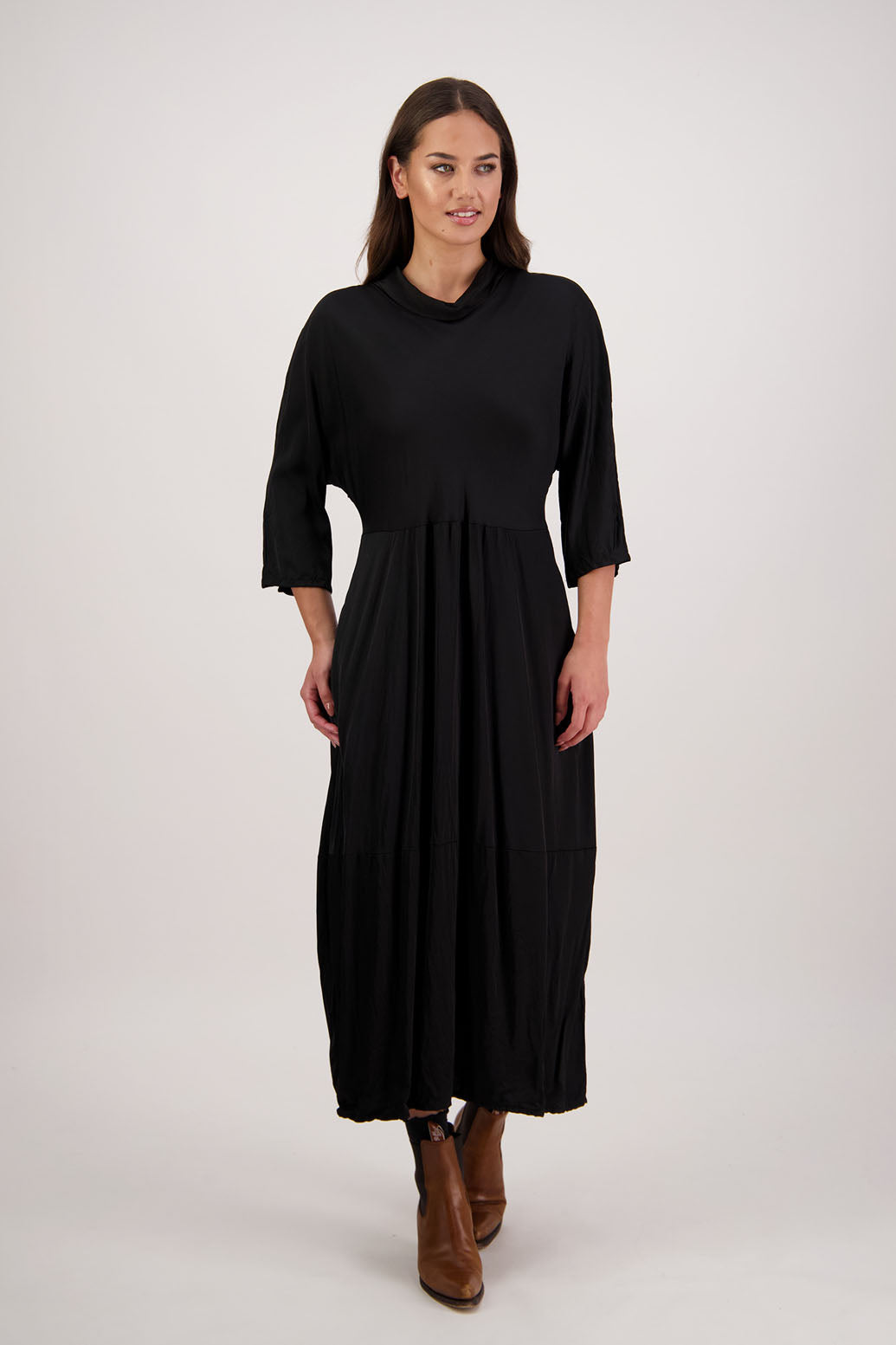 Rowena Dress in Black by Briarwood NZ. 100% viscose dress, roll neck, bias cut top, puff hem start, 3/4 sleeves, pockets, lined