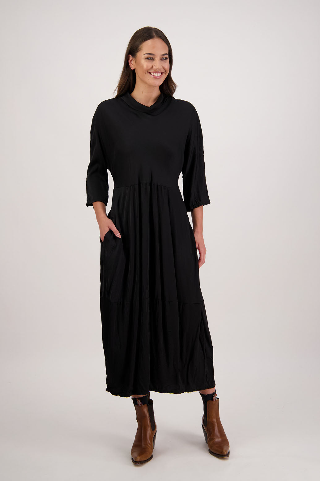 Rowena Dress in Black by Briarwood NZ. 100% viscose dress, roll neck, bias cut top, puff hem start, 3/4 sleeves, pockets, lined