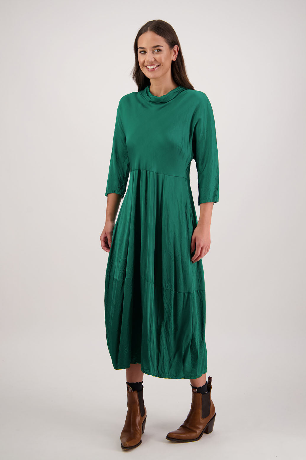 Rowena Dress in Emerald by Briarwood NZ. 100% viscose dress, roll neck, bias cut top, puff hem start, 3/4 sleeves, pockets, lined