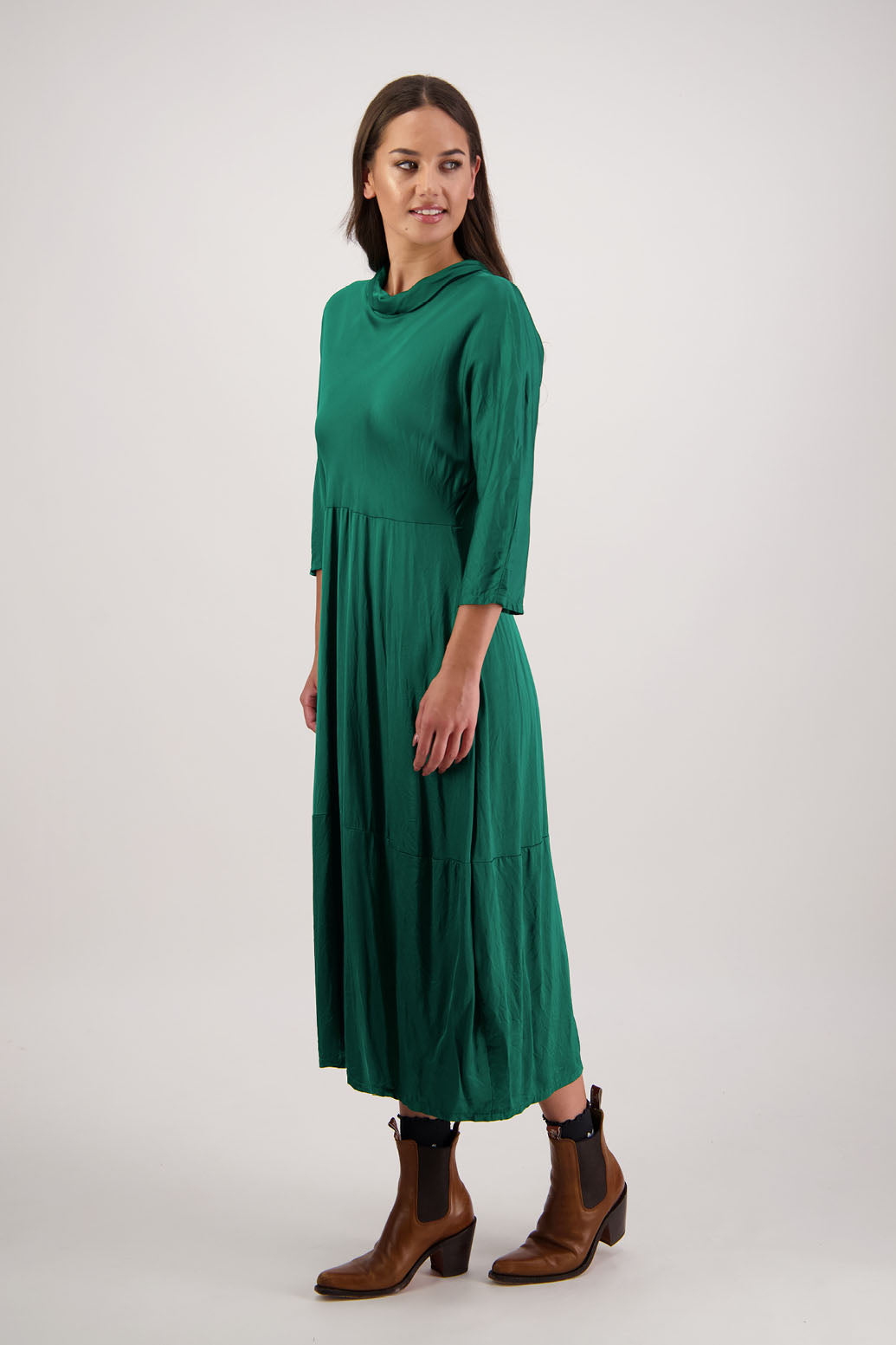 Rowena Dress in Emerald by Briarwood NZ. 100% viscose dress, roll neck, bias cut top, puff hem start, 3/4 sleeves, pockets, lined