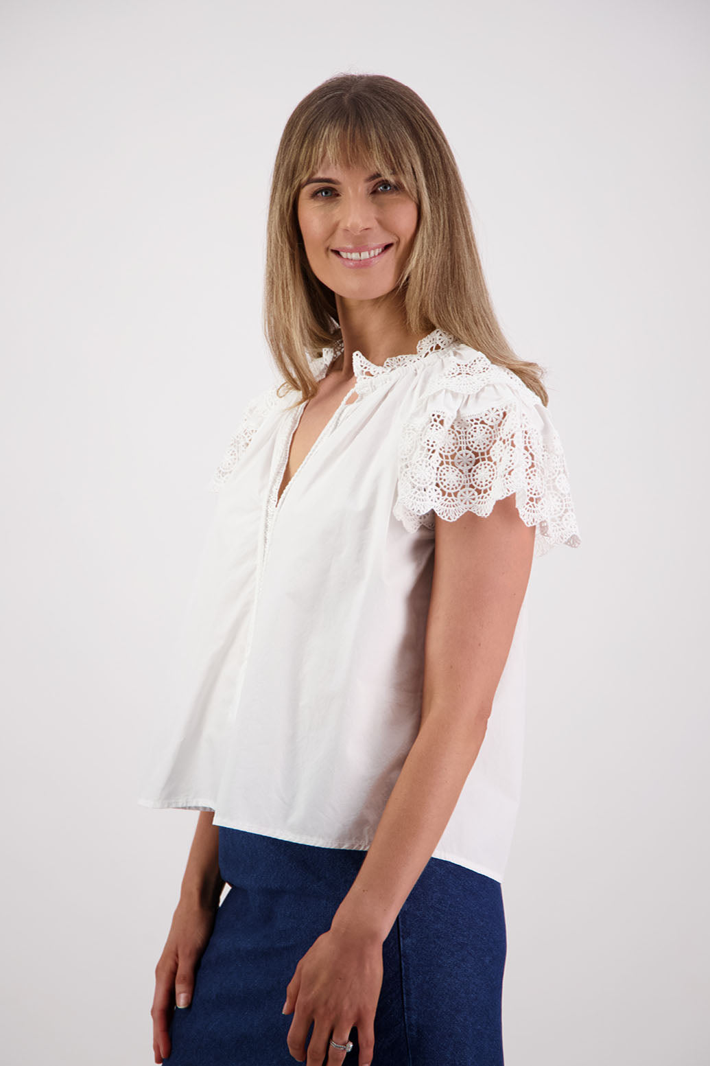 Womens short sleeve white top with lace trim sleeves and lace trim down the front. Briarwood NZ. Cotton Poplin / Lace. Sebbie
